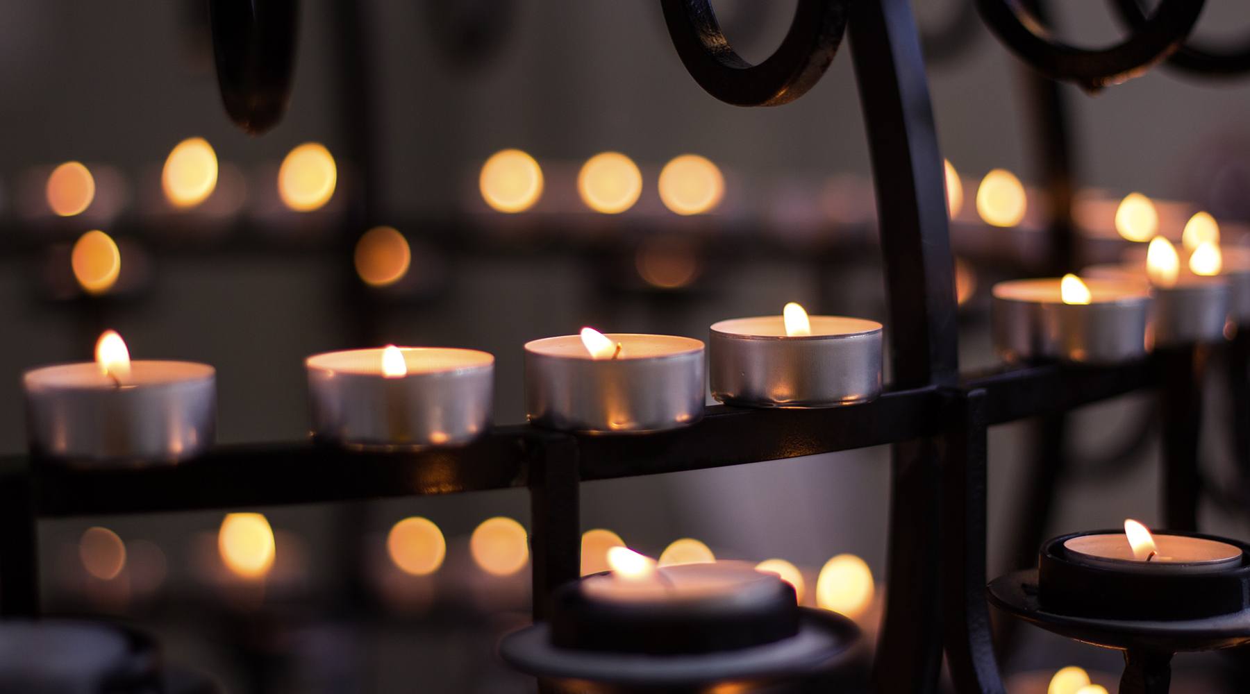 Lit candles in a church in memory of loved ones who have died