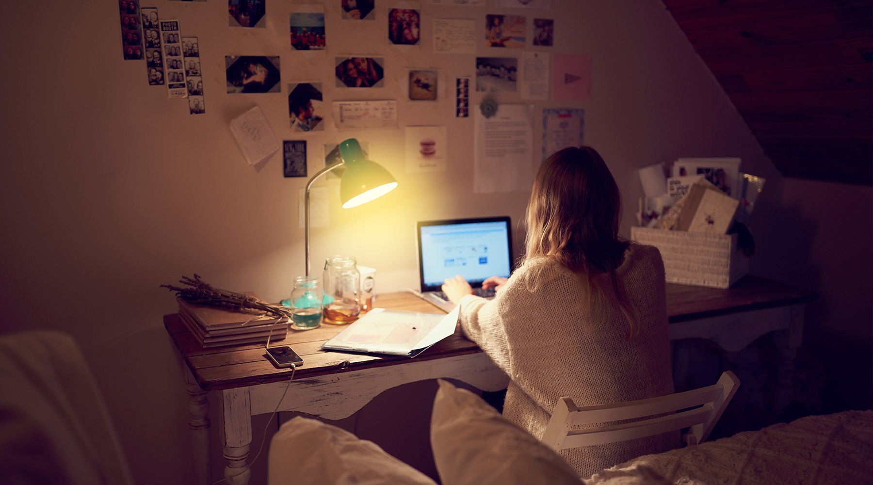 University Student working late in bedroom and suffering from stress